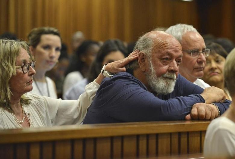 Barry Steenkamp, father of Reeva Steenkamp, is consoled by his wife June Steenkamp during Oscar Pistorius' sentence hearing at the North Gauteng High Court in Pretoria on October 15, 2014